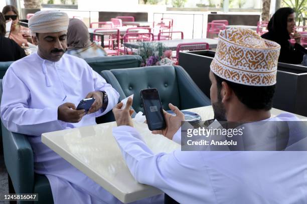 Citizens use their votes by phone as part of online voting system during local elections in Muscat, Oman on December 25, 2022.