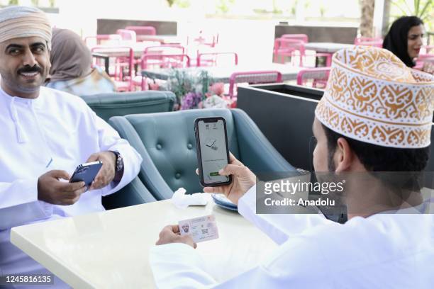 Citizens use their votes by phone as part of online voting system during local elections in Muscat, Amman on December 25, 2022.