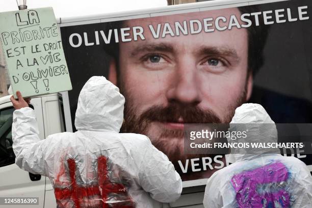 Protesters hold a placard reading 'The priority is the right of living for Olivier' during a solidarity demonstration with Belgian aid worker Olivier...