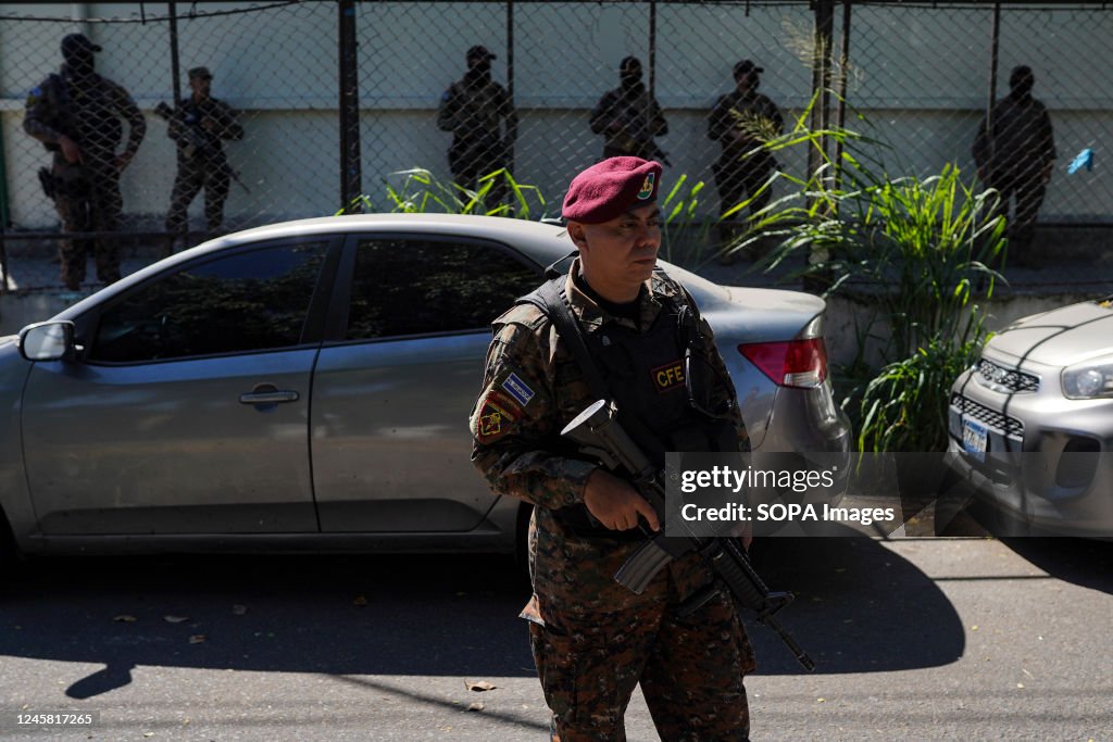 A soldier stands guard at a checkpoint. Police and military perform a ...