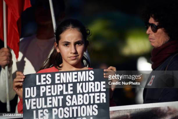 Young kurdish girl holds a placard reading 'Ennemies of the Kurdish people are sabotaging current positions'. The Toulouse's Kurdish community...