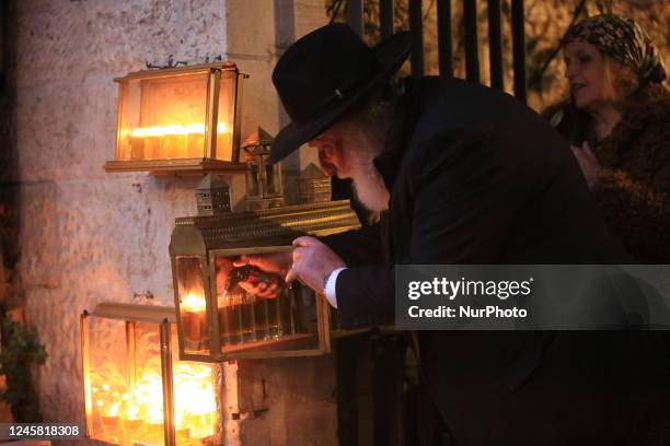 Ultra-Orthodox Jewish men light candles on the seventh night of Hanukkah in the Jewish Quarter of Old Jerusalem, Sunday, December 25, 2022. Hanukkah,...