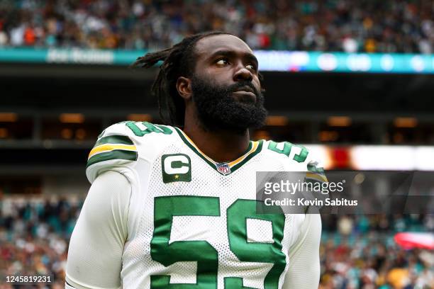 De'Vondre Campbell of the Green Bay Packers stands on the sidelines during the national anthem before an NFL football game against the Miami Dolphins...