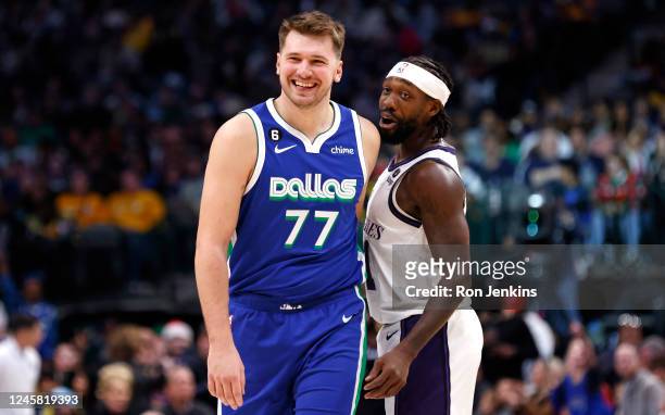 Luka Doncic of the Dallas Mavericks and Patrick Beverley of the Los Angeles Lakers share a laugh in the second half at American Airlines Center on...