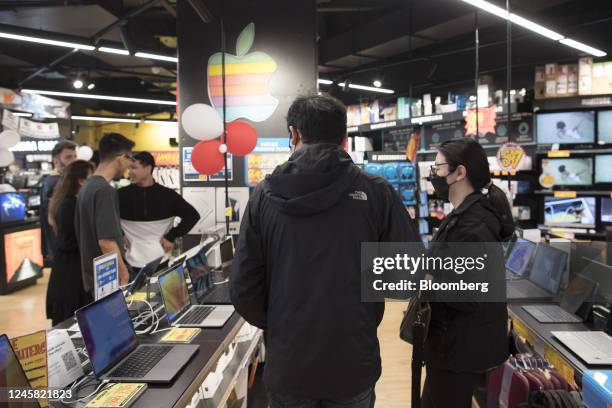 Customers browse laptops at a JB Hi-Fi Ltd. Store in Sydney, Australia, on Monday, Dec. 26, 2022. Australias consumer sentiment remained deeply...