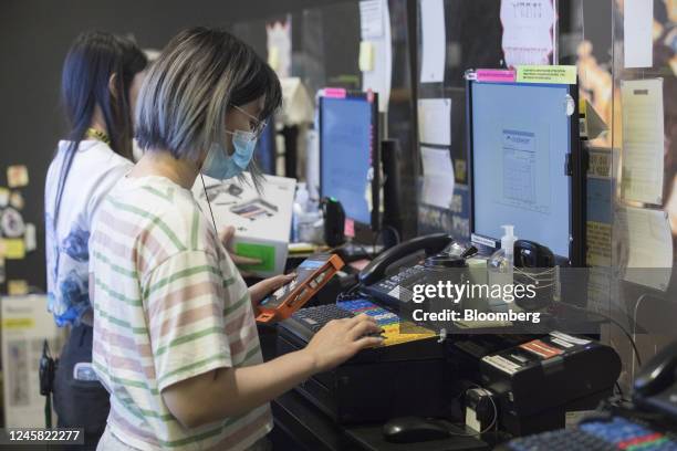 An employee helps a customer at a JB Hi-Fi Ltd. Store in Sydney, Australia, on Monday, Dec. 26, 2022. Australias consumer sentiment remained deeply...