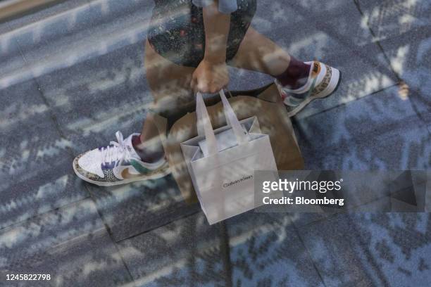 Pedestrian carries a Calvin Klein shopping bag at Pitt Street Mall in Sydney, New South Wales, Australia, on Monday, Dec. 26, 2022. Australias...