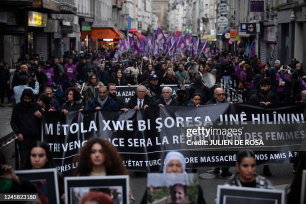 Protesters take part in a demonstration to pay tribute to the Enghien Street shooting victims in Paris on December 23 and to those of La Fayette...