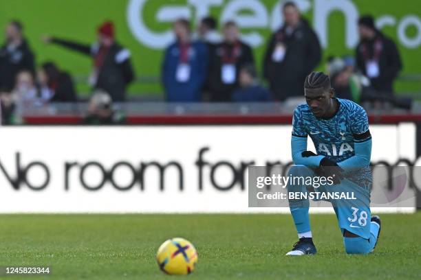 Tottenham Hotspur's Ivorian-born Malian midfielder Yves Bissouma takes a knee in support of the Premier League's No Room For Racism campaign ahead of...