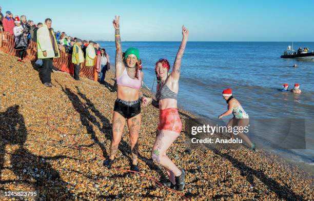 People, dressing Santa hats and outfits for the festive swim, take part in the traditional Boxing Day in Deal, Kent, United Kingdom on December 26,...