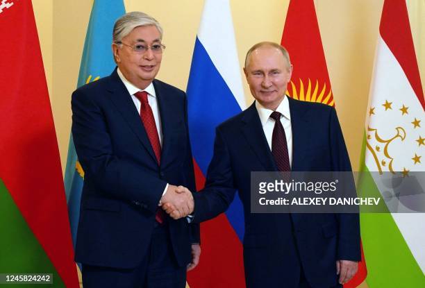 Russian President Vladimir Putin greets Kazakhstan's President Kassym-Jomart Tokayev ahead of an informal meeting of the heads of state of the...