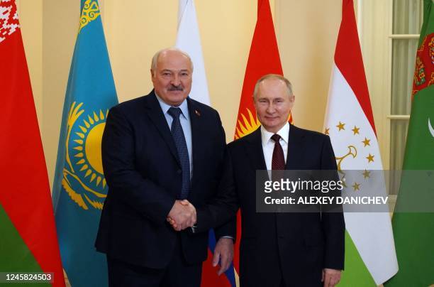 Russian President Vladimir Putin greets Belarus' President Alexander Lukashenko ahead of an informal meeting of the heads of state of the...