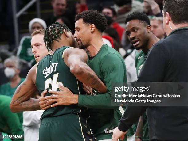 Boston Celtics guard Marcus Smart gets into an altercation with Milwaukee Bucks' Thanasis Antetokounmpo and George Hill on the bench during the...