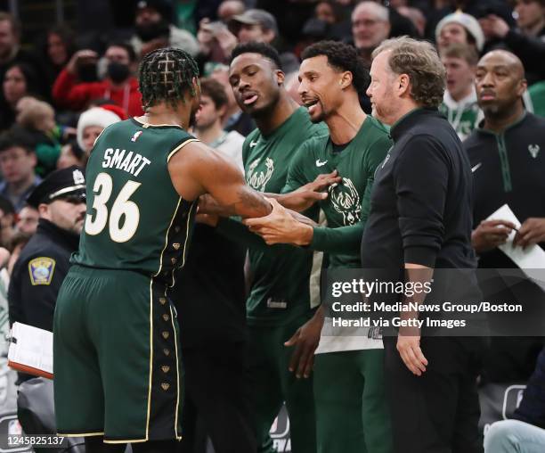 Boston Celtics guard Marcus Smart gets into an altercation with Milwaukee Bucks' Thanasis Antetokounmpo and George Hill on the bench during the...