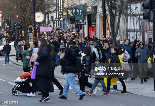 Shoppers cross the road during traditional Boxing Day holiday sales, in London, UK, on Monday, Dec. 26, 2022. Six in 10 adults in the UK surveyed...