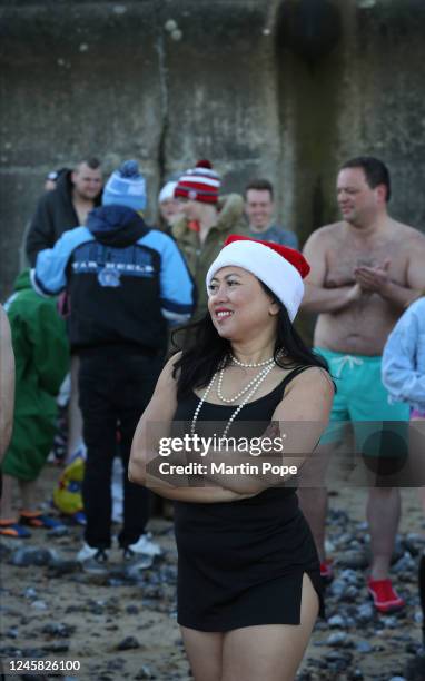 Participant in a Santa hat waits on the beach on December 26, 2022 in Cromer, United Kingdom. The North Norfolk Beach Runners are holding the Boxing...