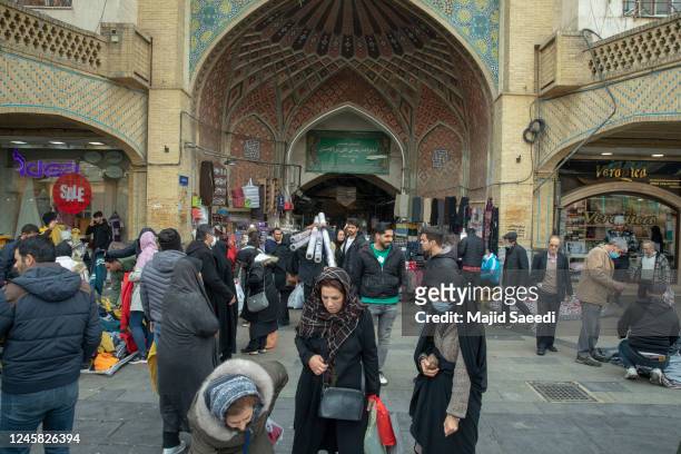 Iranian shoppers shop at Tehran gran bazzar on December 26 in Tehran, Iran's currency has dropped to a new historic low, breaking the 410,000 rial...