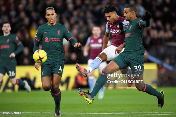 Aston Villa's English striker Ollie Watkins shoots the ball past Liverpool's German-born Cameroonian defender Joel Matip and Liverpool's Dutch...