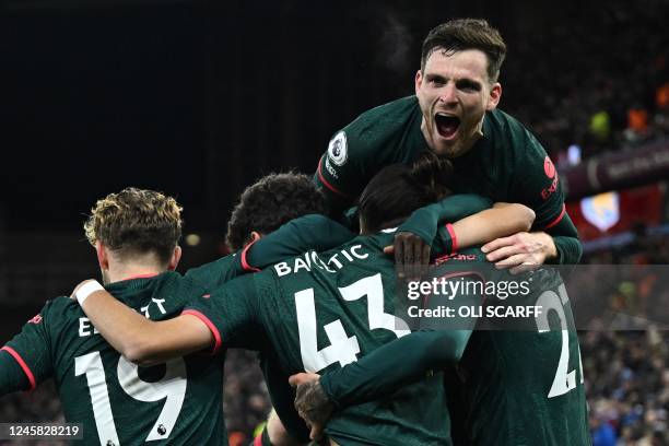 Liverpool's Spanish defender Stefan Bajcetic celebrates with teammates after scoring his team third goal during the English Premier League football...