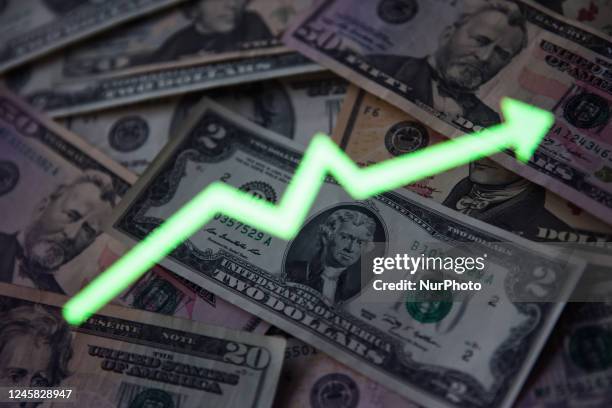 United States dollar banknotes and an illustrative stock graph displayed on a screen are seen in this multiple exposure illustration photo taken in...