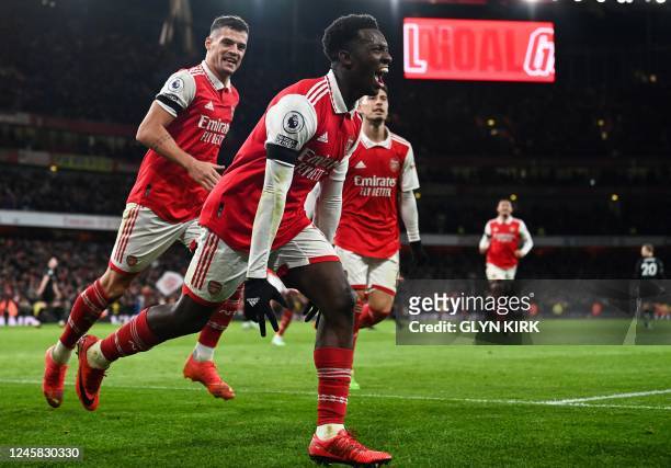 Arsenal's English striker Eddie Nketiah celebrates after scoring his team third goal during the English Premier League football match between Arsenal...