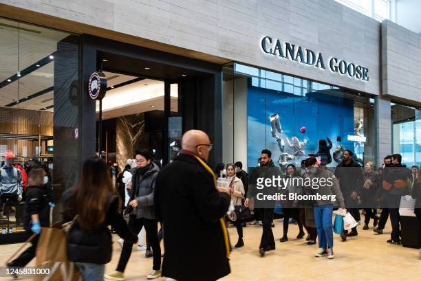 Shoppers pass a Canada Goose store at a mall on Boxing Day in Toronto, Ontario, Canada, on Monday, Dec. 26, 2022. The consumer price index rose 6.8%...