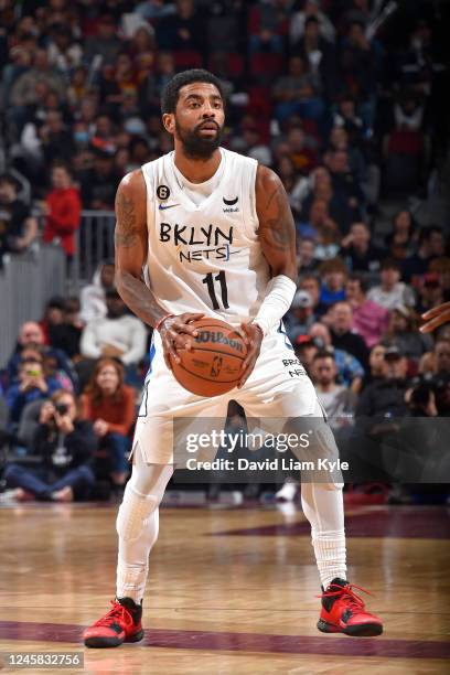 Kyrie Irving of the Brooklyn Nets looks to pass the ball during the game against the Cleveland Cavaliers on December 26, 2022 at Rocket Mortgage...