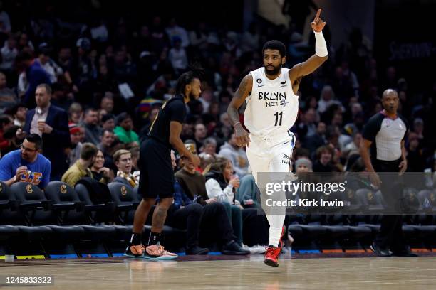 Kyrie Irving of the Brooklyn Nets reacts after making a three-point shot during the third quarter of the game against the Cleveland Cavaliers at...