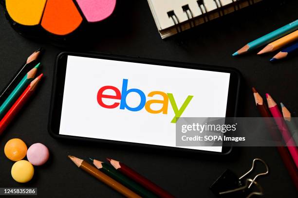 In this photo illustration an eBay logo seen displayed on a smartphone.