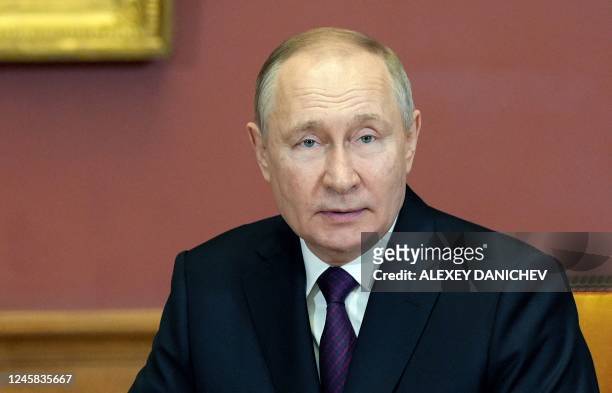 Russia's President Vladimir Putin looks on during a meeting with his Belarus counterpart on the sidelines of an informal summit of the heads of state...