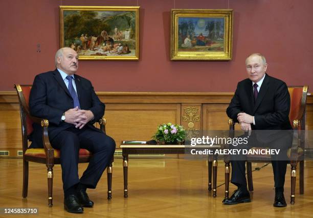 Russia's President Vladimir Putin speaks with his Belarus counterpart Alexander Lukashenko during their meeting on the sidelines of an informal...