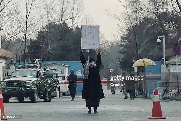 This picture taken on December 25, 2022 shows student Marwa protesting alone against the ban on women's higher education, outside the Kabul...