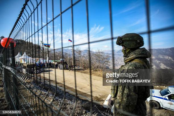 Russian peacekeeper guards the Lachin corridor, the Armenian-populated breakaway Nagorno-Karabakh region's only land link with Armenia, as...