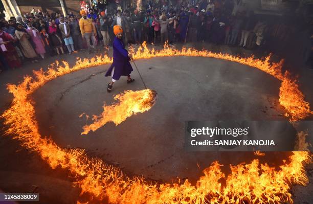 Sikh performer demonstrates his skills during a religious procession ahead of the birth anniversary celebrations of the tenth Guru of the Sikhs, Guru...