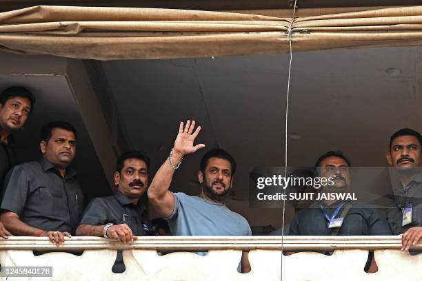 Bollywood actor Salman Khan greets his fans who gathered outside his residence to wish him on his birthday, in Mumbai on December 27, 2022.