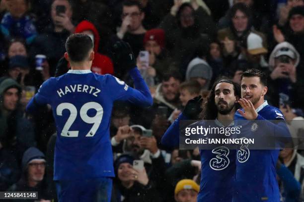 Chelsea's English midfielder Mason Mount celebrates with teammates after scoring his team second goal during the English Premier League football...
