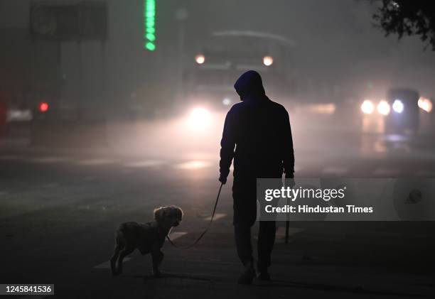 Commuters out on a smoggy morning in sector 22 on December 27, 2022 in Noida, India. The lowest minimum temperature in Delhi NCR was recorded at...