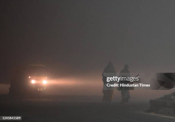 Delhiites brave the early morning heavy Fog and Winter Chill, at Dwarka on December 27, 2022 in New Delhi, India. The lowest minimum temperature in...