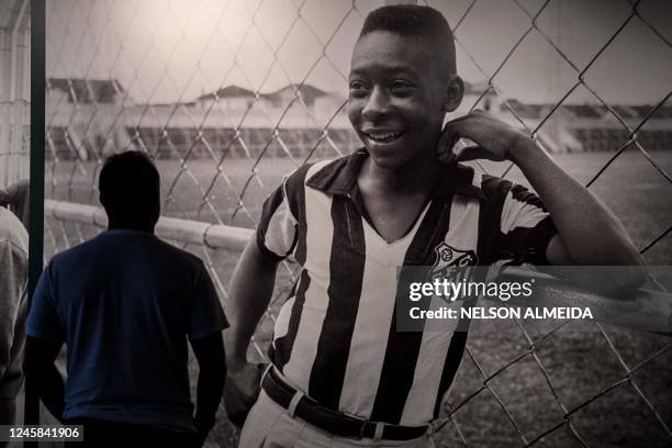 Visitor looks at a picture of Brazil's football legend Edson Arantes do Nascimento 'Pele', exhibited at the Pele Museum, in Santos, Brazil, on...