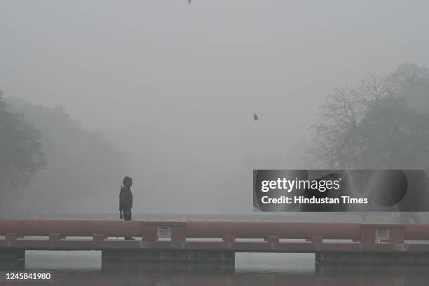 Delhiites brave the early morning heavy Fog and Winter Chill, at India Gate Lawns on December 27, 2022 in New Delhi, India. The lowest minimum...