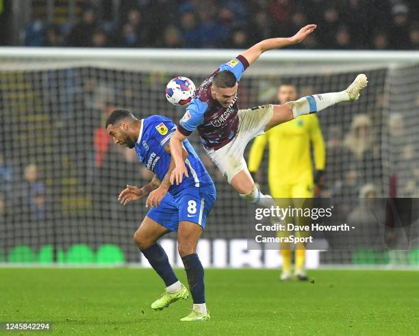 Burnley's Taylor Harwood-Bellis battles with Birmingham City's Troy Deeney during the Sky Bet Championship between Burnley and Birmingham City at...