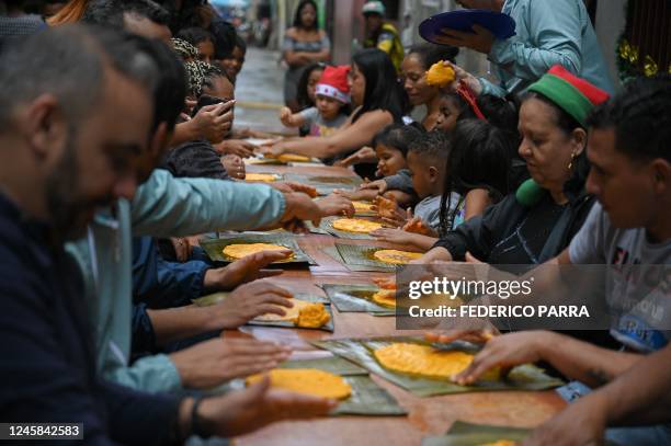 People learn to make "hallacas" -typical venezuelan Christmas dish- during an activity organized by the "Cuento Contigo Siempre" foundation at the...