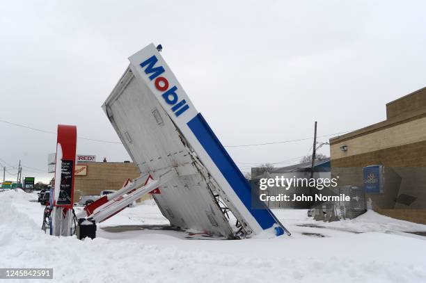 Gas station canopy lays on its side after high winds and heavy snow along Lake Shore Boulevard on December 27, 2022 in Lackawanna, New York. The...
