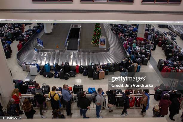 Stranded travelers search for their luggage at the Southwest Airlines Baggage Claim at Midway Airport on December 27, 2022 in Chicago, Illinois. A...