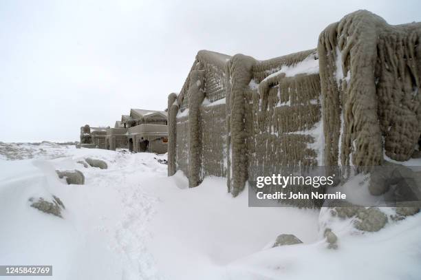 Homes are covered with ice after being battered with waves from Lake Erie along Hoover Beach on December 27, 2022 in Hamburg, New York. The historic...