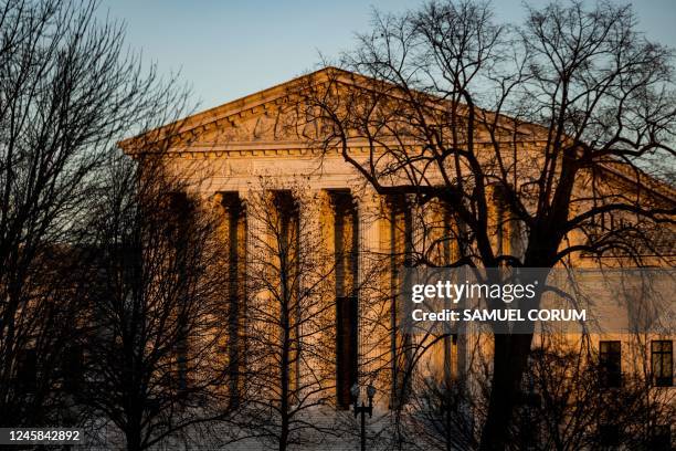 The US Supreme Court is illuminated by the setting sun in Washington, DC, on December 21, 2022. - The US government's two-year-old policy of invoking...