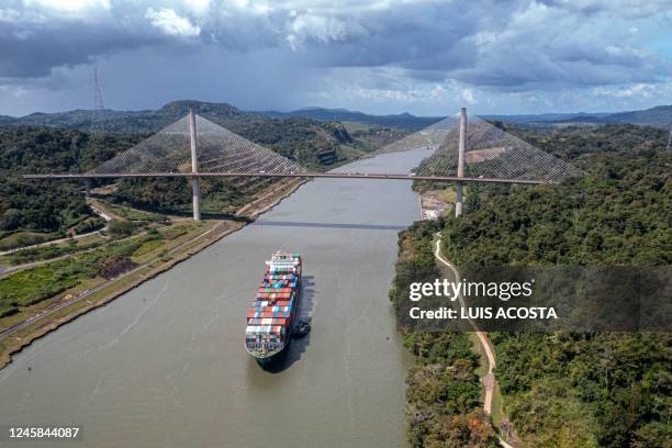 Aerial view of Panama canal in the area of Pedro Miguel locks, in Panama City on December 13, 2022. - Every time a ship crosses the Miraflores Lock,...