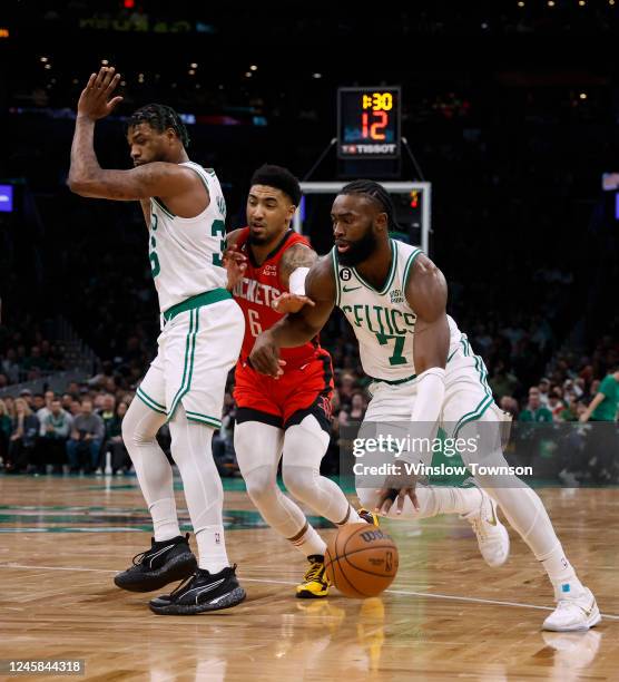 Jaylen Brown of the Boston Celtics goes past a Marcus Smart pick on Kenyon Martin Jr. #6 of the Houston Rockets during the second quarter at TD...