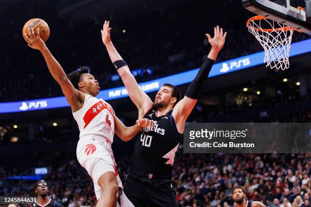 Scottie Barnes of the Toronto Raptors puts up a shot over Ivica Zubac of the LA Clippers during the first half of their NBA game at Scotiabank Arena...