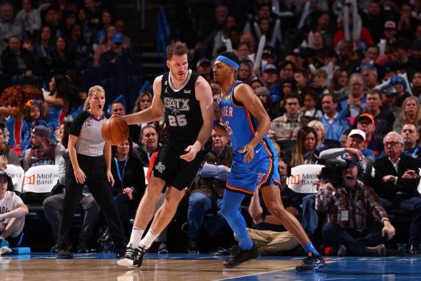 Jakob Poeltl of the San Antonio Spurs drives to the basket against the Oklahoma City Thunder on December 27, 2022 at Paycom Arena in Oklahoma City,...